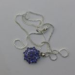A blue stone pendant on a silver chain
