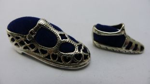 Two small silver shoe formed pin cushions