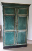 A large green painted panelled wardrobe