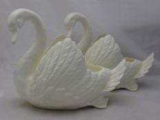 A pair of white ceramic swan planters