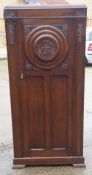 An early 20th century carved oak wardrobe