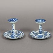 A pair of Chinese blue and white porcelain candle stands Each decorated with phoenixes and bamboo