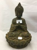 A bronze model of buddha praying