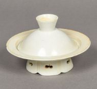A Chinese porcelain cup with stand With lappet moulding and pierced foot. 8.5 cm high overall.