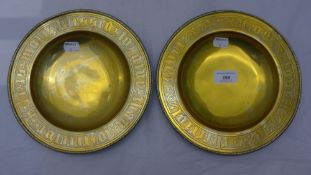 A pair of brass alms dishes