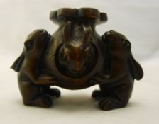 A Japanese carved and stained wood netsuke,