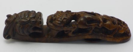 A Chinese carved wooden belt hook