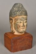 A Chinese terracotta Buddha's head Mounted on a later plinth base. 26 cm high overall.