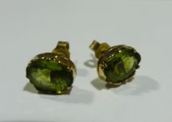 A pair of 9 ct gold peridot set ear studs