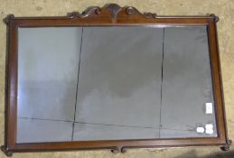 A mahogany framed wall glass