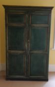 A large green painted panelled wardrobe