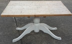 A pine kitchen table with white painted base