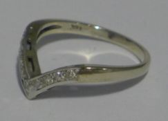 A white gold diamond wishbone ring