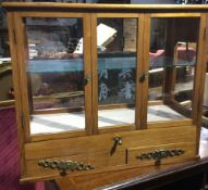 An oak glazed cabinet