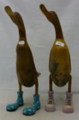 A pair of wooden ducks in boots