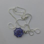 A blue stone pendant on a silver chain