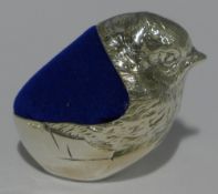 A silver pin cushion in the form of a chick