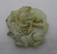 A Chinese carved jade good luck charm worked with a chicken surmounting an elephant