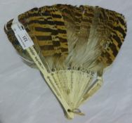 A decorated feather and bone fan