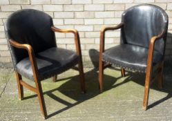 A pair of leather armchairs