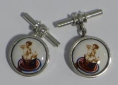 A pair of silver cufflinks depicting nudes