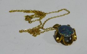 A 9 ct gold opal set pendant on a 9 ct gold chain (3 grammes all in)