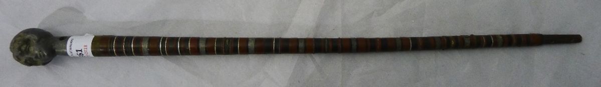 A small stick with female bust handle