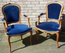 A pair of blue upholstered armchairs