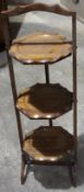 A mahogany cake stand and a Victorian walnut tripod table