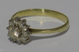 A yellow metal diamond set cluster ring