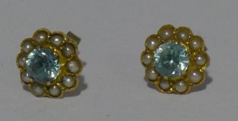 A pair of 9 ct gold stud earrings set with natural blue zircon and seed pearls