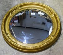 A gilt framed convex wall glass