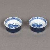 A pair of Chinese blue and white porcelain shallow cups Each decorated with a temple lion,
