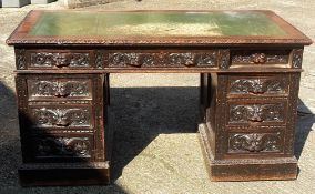 A Victorian carved oak pedestal desk