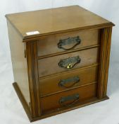 A small Victorian Wellington type bank of walnut drawers