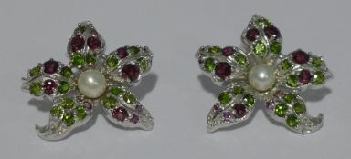 A pair of 925 silver flower shaped stud earrings set with green diopsides,