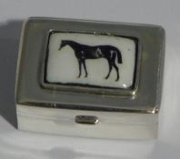 A silver pill box depicting a horse