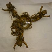 A gilt hanging light formed as cherubs