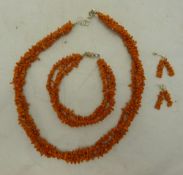 A suite of coral bead jewellery, comprising: necklace, bracelet and a pair of earrings (one a/f),