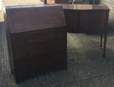 A modern sideboard and an oak bureau