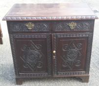 A 19th century carved oak side cupboard