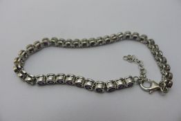 A silver dress bracelet set with red stones