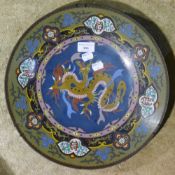 A cloisonne charger decorated with a dragon