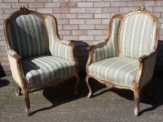 A pair of gilt armchairs