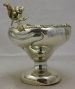A silver plated tazza mounted with a squirrel