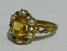 A 9 ct gold seed pearl and citrine set flowerhead ring (3 grammes all in)