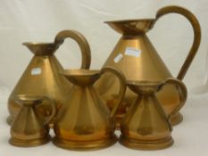 A set of five graduated copper harvest jugs,
