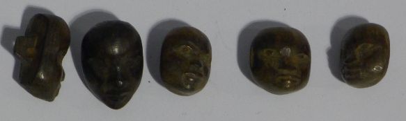 A small collection of Benin carved wooden mask buttons