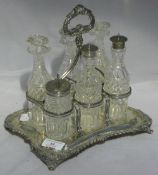 A silver cruet stand and silver mounted bottles, Birmingham 1903, maker's mark of Elkington and Co.