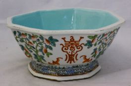 An octagonal Chinese porcelain bowl decorated with peach trees and bats